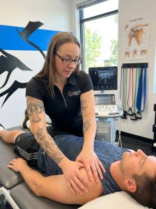 Patient receiving manual therapy at a sports medicine clinic in Centennial 