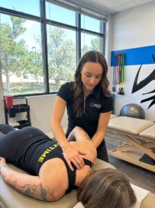 Patient working with a provider at a sports rehabilitation clinic in Centennial, CO performing corrective exercises for performance optimization
