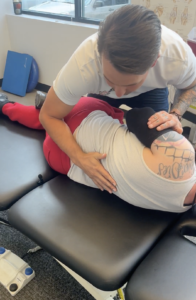 Patient receiving manual therapy on their low back at a chiropractic and sports rehab clinic in Centennial, CO
